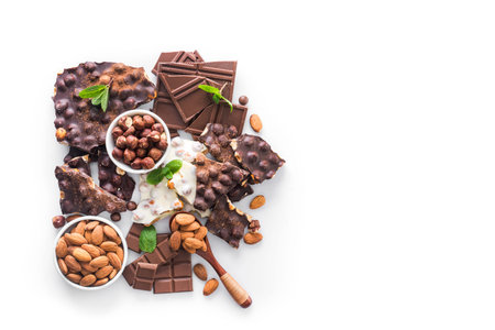 tasty chocolate bars with nuts, fresh mint and almond isolated on white background, top view