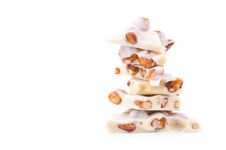 delicious bar of milk chocolate with nuts isolated on a white backgroundの写真素材