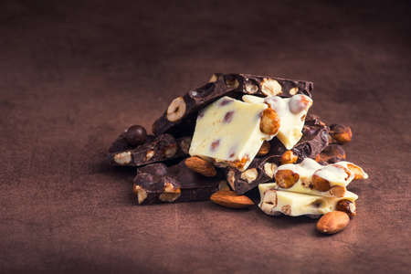 slide of milk and dark chocolate on a stone backgroundの写真素材