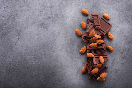 sweet chocolate bars with almond on a stone table, top viewの写真素材