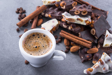 Aroma coffee cup with chocolate bars on a stone table, top view