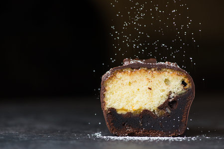chocolate sweet cake with fly powder on a dark backgroundの写真素材