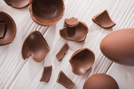 easter tasty chocolate egg on a wooden table. holiday candy dessertの写真素材