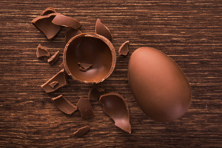 easter tasty chocolate egg on a wooden table. holiday candy dessert