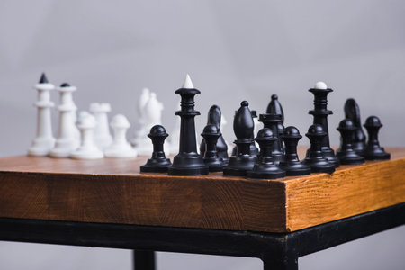 A set of white chess on a wooden surface