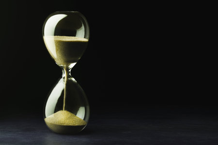 Retro hourglass with two transparent flask with sand on background. Time passing concept