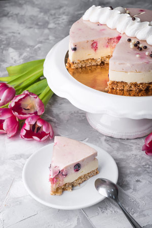 Dessert cake with tulips flowers on a background. A gift to a woman on March 8th holiday,...
