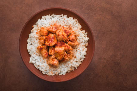 indian chicken curry with white rice on a brown background. hot food lunchの写真素材