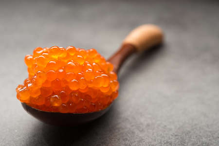 Closeup of spoon with red caviar on a background. appetizer seafoodの写真素材