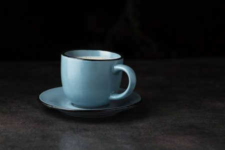 Blue cup with tasty coffee on a stone tableの写真素材