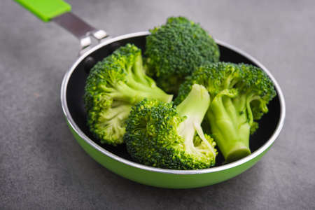 Fresh raw green broccoli in a frying pan. Diet concept background.の写真素材