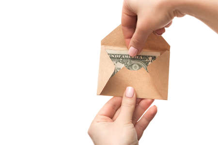 An envelope with dollars in hand, isolated on a white background. Monetary assistance in lending. cash or pecuniary aidの写真素材