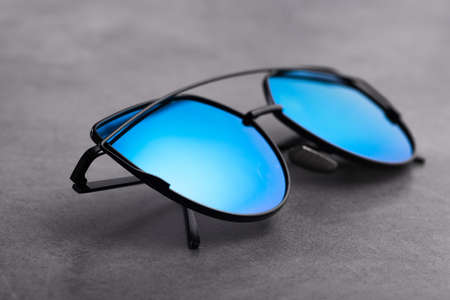 Modern black eye glasses on a stone backgroundの写真素材