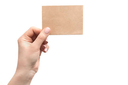 Woman hand holding old paper card isolated on a white backgroundの写真素材