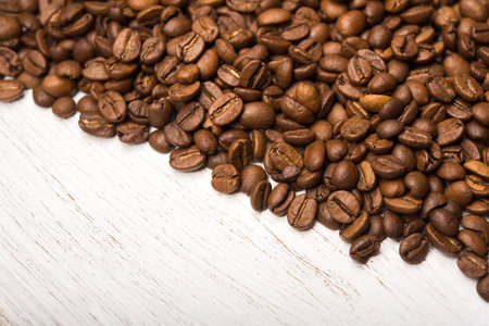 Closeup of coffee roasted beans on a background