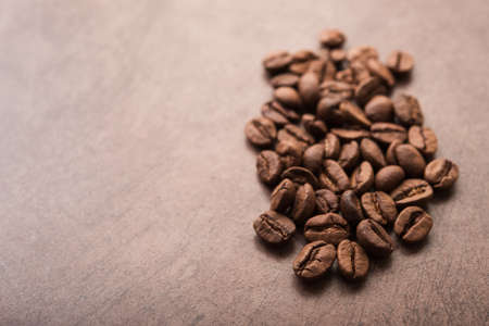 Closeup of natural coffee beans on a wooden tableの写真素材