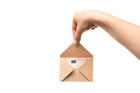Woman hands holds an envelope with euro banknotes isolated on a white background. Home mortgage loan. home savingsの写真素材