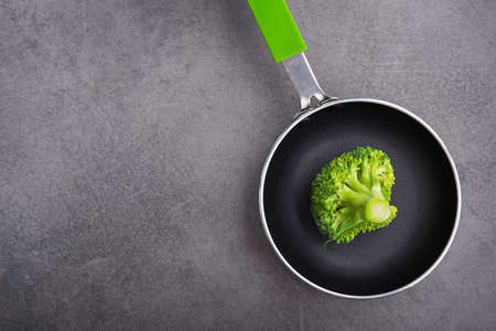 Fresh raw green broccoli in a frying pan. Diet concept background. Top viewの写真素材