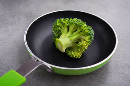 Fresh raw green broccoli in a frying pan. Diet concept background.の写真素材