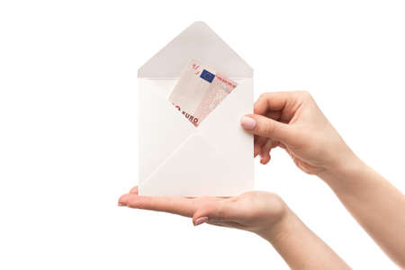 Woman hands holds an envelope with euro banknotes isolated on a white background. mortgage loan. home savings for buying a houseの写真素材