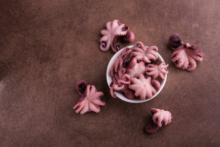 Small octopus on a stone table background. Seafood meal. Top view.の写真素材