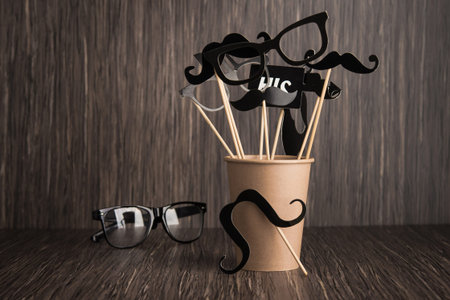 Black photo booth man mustache on a wooden background. Retro style element of hipster party. top...