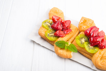 Sweet bakery with strawberry and kiwi in sugar glaze. Summer dessert food.