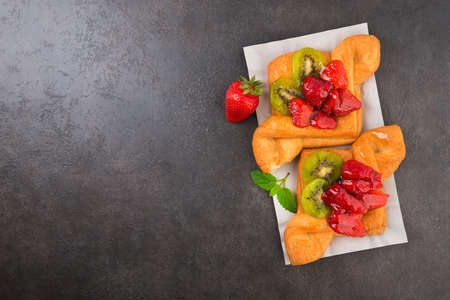 Sweet bakery with strawberry and kiwi in sugar glaze. Summer dessert food.の写真素材