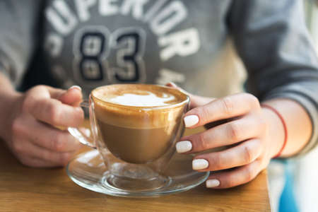 young woman holding coffee cup in a cafe. good morning conceptの写真素材