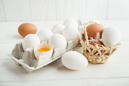 raw white eggs in the tray on a wooden table