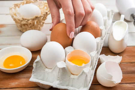 Raw organic eggs in the tray on a wooden table. dairy cooking food