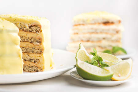 Tasty homemade lemon cake on a white tablecloth. Sweet dessert food background.の写真素材