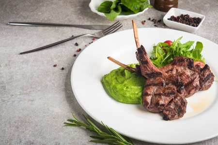 Fresh steak with a side dish on a stone background. Grilled restaurant cooked food.の写真素材