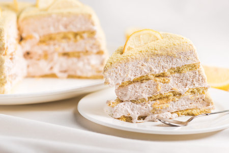 A piece of lemon cake on a white tablecloth. Sweet dessert food.の写真素材
