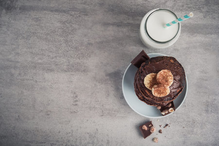 Sweet chocolate pancake with banana on a stone background. high-calorie breakfast. junk food