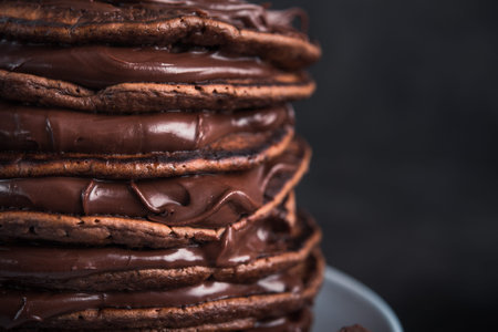 Sweet chocolate pancakes on a stone background. high-calorie breakfast. not healthy food