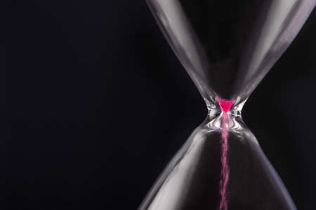 Bright colored time with hourglassの写真素材