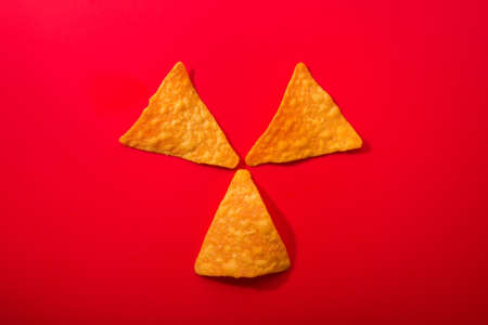 Golden nacho chips on a redの写真素材