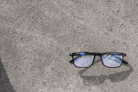 Broken glasses lying on the street asphalt. an unpleasant situation on the roadの写真素材