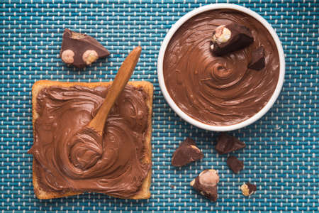 Sweet chocolate spread on bread with cream and bars. Top view.の写真素材