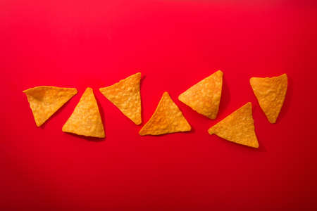 Golden nacho chips on a redの写真素材