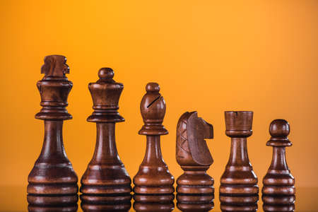 Chess set of pieces on a yellowの写真素材