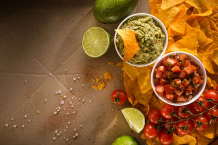 Delicious golden crispy chips with salsa and guacamole sauce. mexican food. flat lay.top viewの写真素材