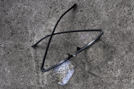 Broken glasses lying on the street asphalt. an unpleasant situation on the roadの写真素材