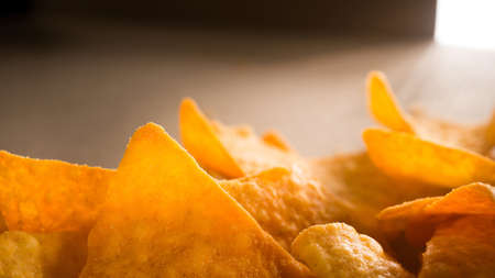 Golden nachos chips on a craft paper boxの写真素材