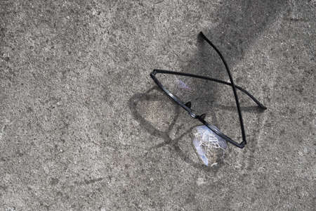 Broken glasses lying on the street asphalt. an unpleasant situation on the roadの写真素材