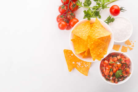 Mexican tomato salsa with tortilla chips on a whiteの写真素材
