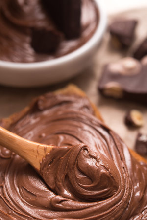 Sweet chocolate spread on bread with cream and bars.