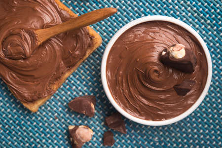Sweet chocolate spread on bread with cream and bars. Top view.の写真素材