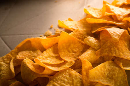 Golden nachos chips on a craft paper boxの写真素材
